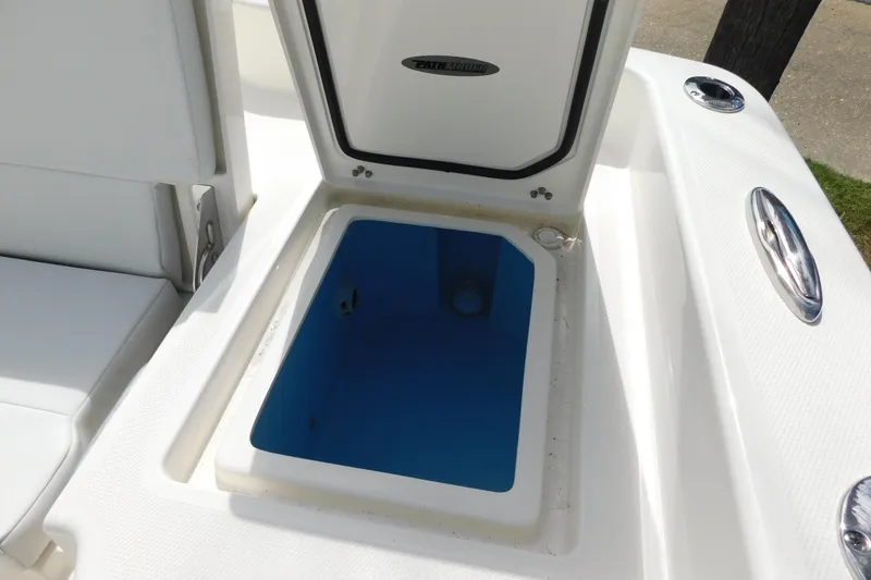 Slide: The Image of Open storage compartment on 2026 Pathfinder 2400 TRS boat, featuring blue interior. - 21