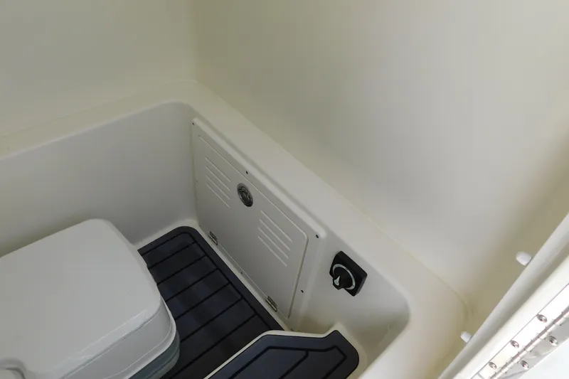 Slide: The Image of 2026 Pathfinder 2400 TRS boat interior with storage compartment and seating. - 38