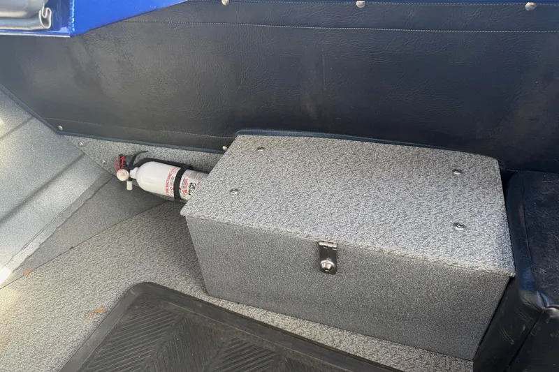 Slide: The Image of Interior of 2006 Custom Weld Cobra OB boat with fire extinguisher and storage compartment. - 14