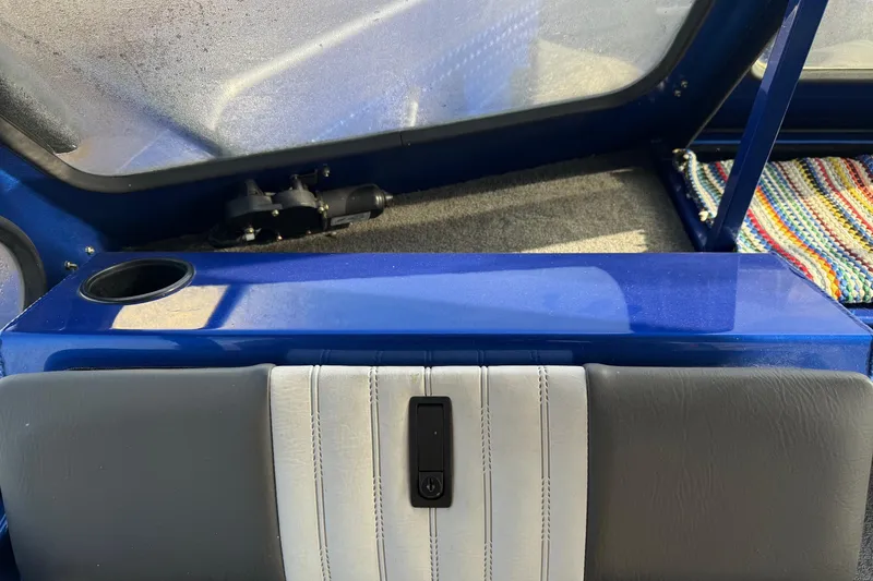 Slide: The Image of Interior of 2006 Custom Weld Cobra OB boat with blue and gray seating. - 15