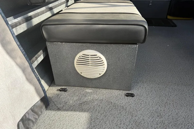 Slide: The Image of Interior of 2006 Custom Weld Cobra OB boat with cushioned seating and speaker. - 18