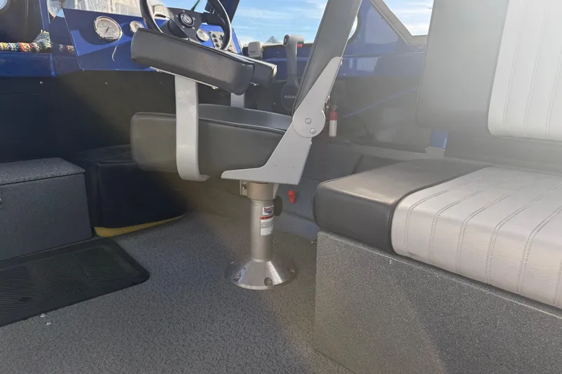 Slide: The Image of Interior of a 2006 Custom Weld Cobra OB boat showing seating and steering area. - 19