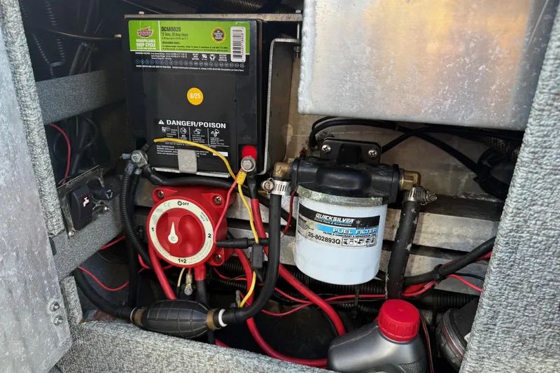 Slide: The Image of 2006 Custom Weld Cobra OB engine compartment with battery, fuel filter, and wiring. - 21