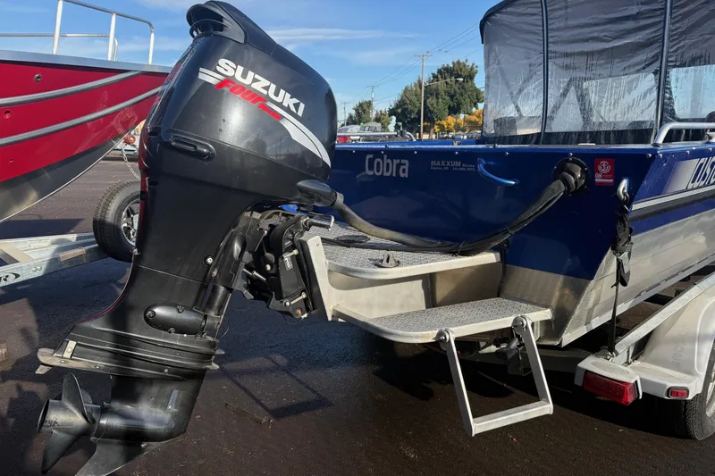 Slide: The Image of 2006 Custom Weld Cobra OB boat with Suzuki outboard motor on trailer. - 6