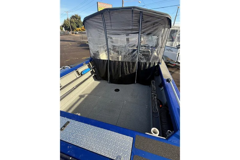 Slide: The Image of 2006 Custom Weld Cobra OB boat with covered seating area and spacious deck. - 7