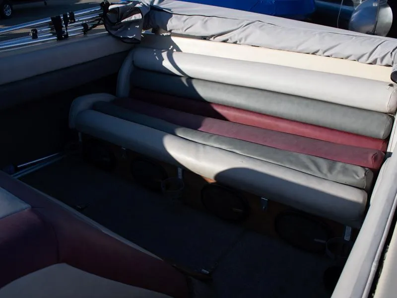 Slide: The Image of 1987 Baja 190 Sport boat interior with cushioned seating and storage compartments. - 11