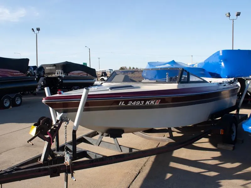 Slide: The Image of 1987 Baja 190 Sport boat on trailer in outdoor lot. - 3