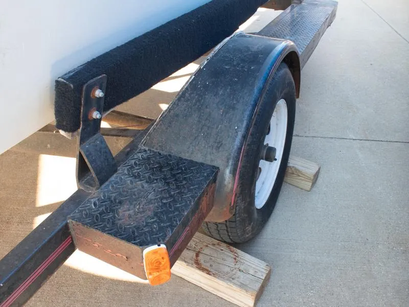 Slide: The Image of 1987 Baja 190 Sport trailer with black fender and white wheel on wooden blocks. - 7