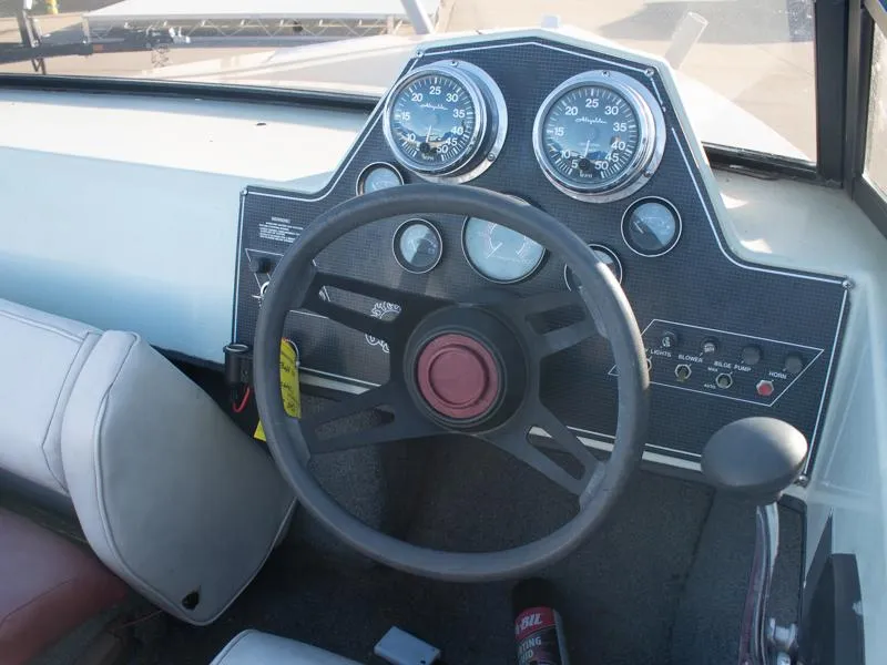 Slide: The Image of 1987 Baja 190 Sport boat dashboard with steering wheel and gauges. - 8
