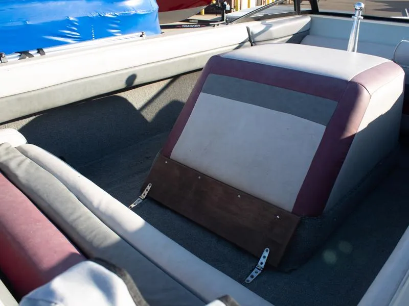Slide: The Image of 1987 Baja 190 Sport boat interior with cushioned seating and storage area. - 9