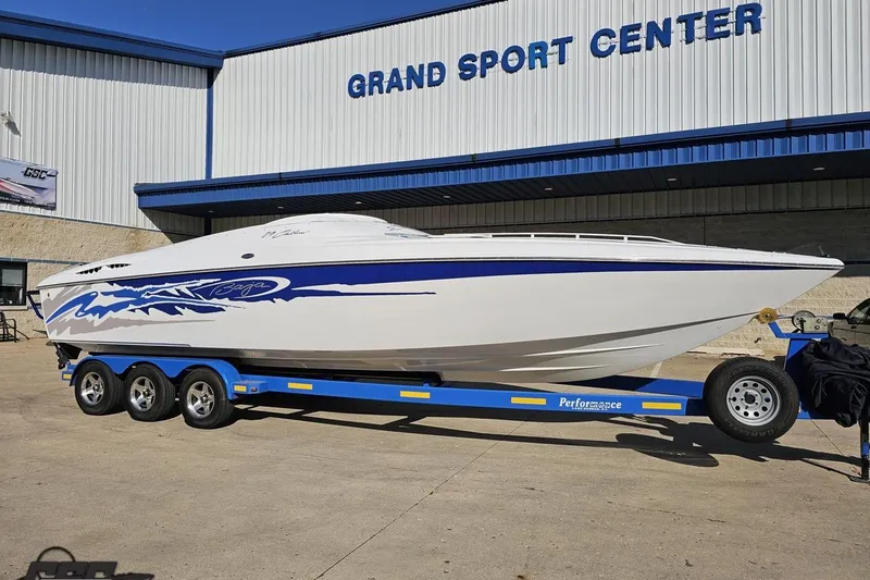Slide: The Image of 2004 Baja 29 Outlaw boat on trailer at Grand Sport Center. - 11