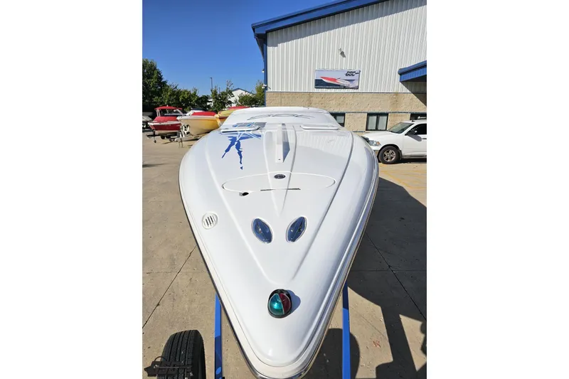 Slide: The Image of 2004 Baja 29 Outlaw speedboat displayed outdoors, showcasing sleek design and vibrant graphics. - 14