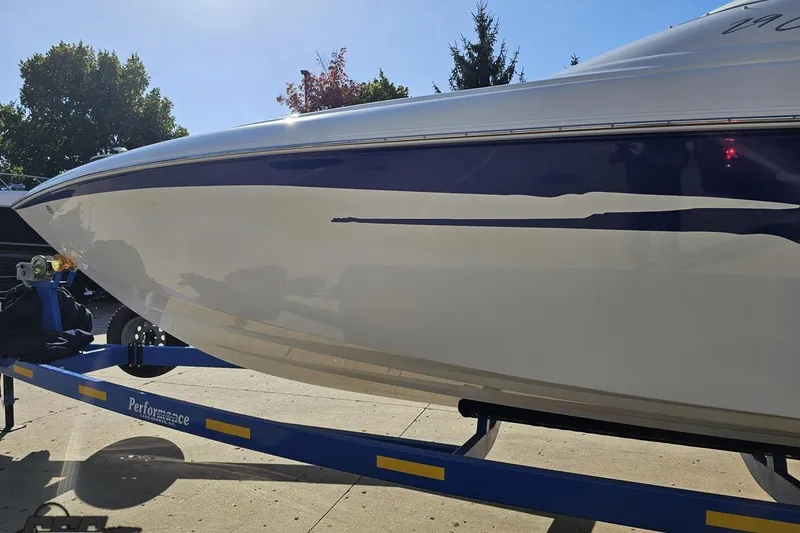 Slide: The Image of 2004 Baja 29 Outlaw boat on trailer, sleek design, sunny day. - 20