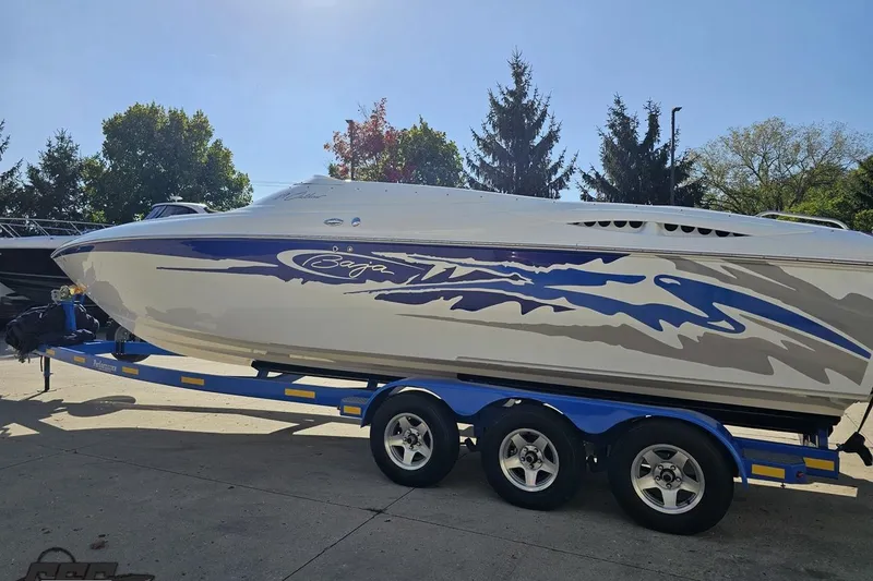 Slide: The Image of 2004 Baja 29 Outlaw speedboat on trailer, featuring sleek design and vibrant graphics. - 25