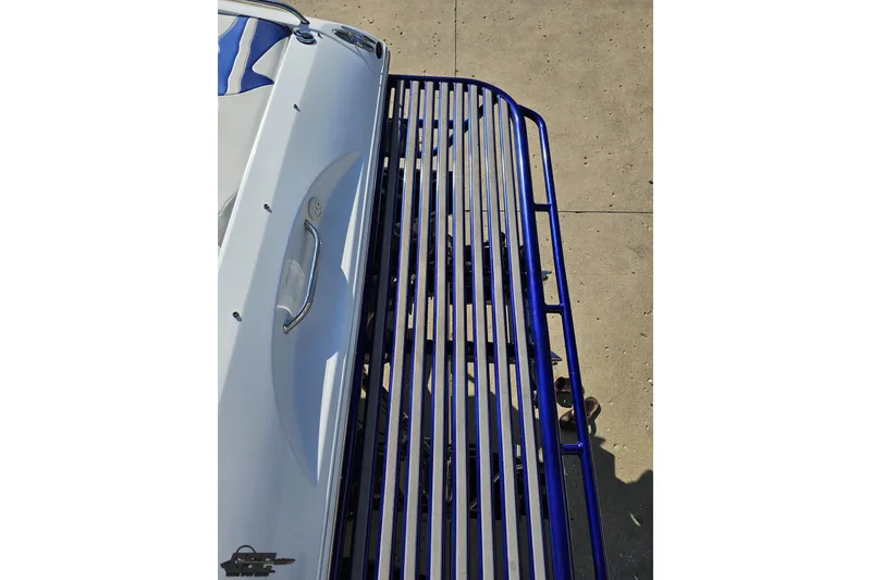 Slide: The Image of 2004 Baja 29 Outlaw boat on a blue metal trailer, top view. - 34