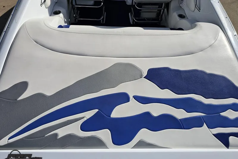 Slide: The Image of 2004 Baja 29 Outlaw boat interior with blue, gray, and white upholstery design. - 36