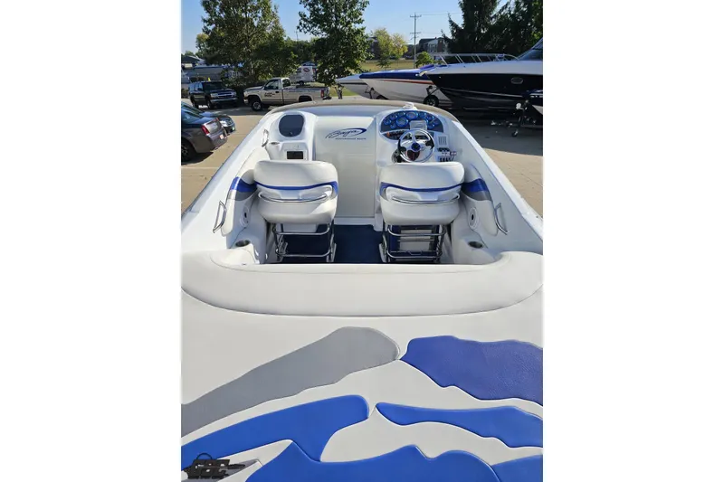 Slide: The Image of 2004 Baja 29 Outlaw boat interior with blue and white seating and dashboard. - 37