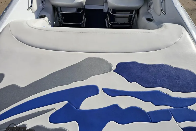 Slide: The Image of 2004 Baja 29 Outlaw boat interior with blue and gray upholstery design. - 38