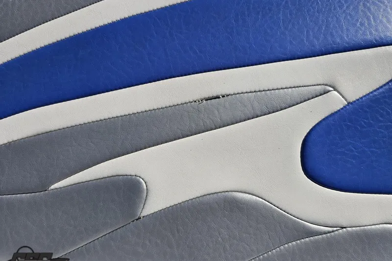 Slide: The Image of Blue, gray, and white leather upholstery detail from a 2004 Baja 29 Outlaw boat. - 40