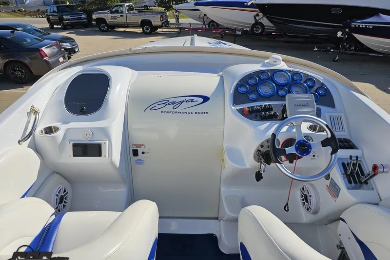 Slide: The Image of 2004 Baja 29 Outlaw boat cockpit with steering wheel and gauges. - 45