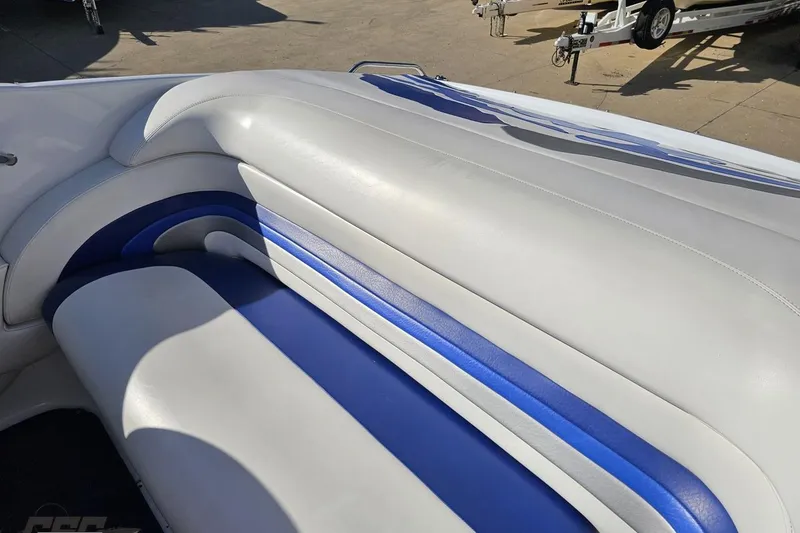Slide: The Image of 2004 Baja 29 Outlaw boat interior with white and blue seating. - 46