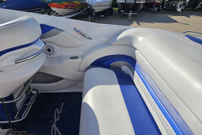 Slide: The Image of Interior of a 2004 Baja 29 Outlaw boat with blue and white seating. - 47