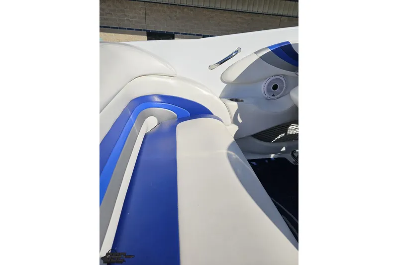 Slide: The Image of 2004 Baja 29 Outlaw boat interior with blue and white seating. - 49