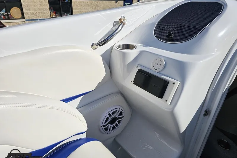 Slide: The Image of 2004 Baja 29 Outlaw boat interior with white seating and audio controls. - 51