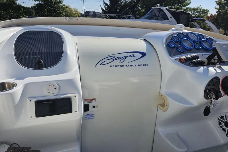 Slide: The Image of 2004 Baja 29 Outlaw boat dashboard with gauges and controls. - 52