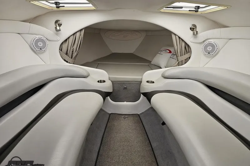 Slide: The Image of Interior of 2004 Baja 29 Outlaw boat, featuring sleek white seating and modern design. - 59