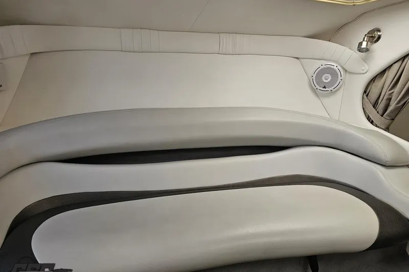 Slide: The Image of 2004 Baja 29 Outlaw interior with white leather seating and speaker detail. - 60