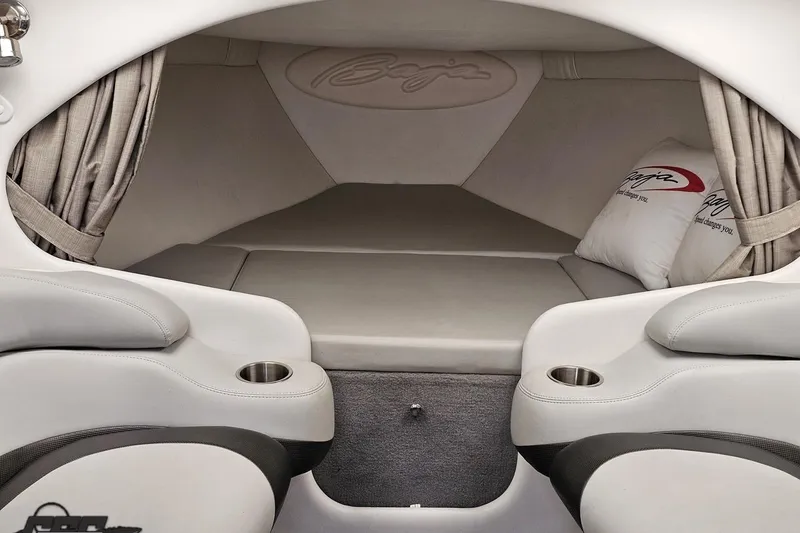 Slide: The Image of 2004 Baja 29 Outlaw cabin interior with cushioned seating and cup holders. - 62