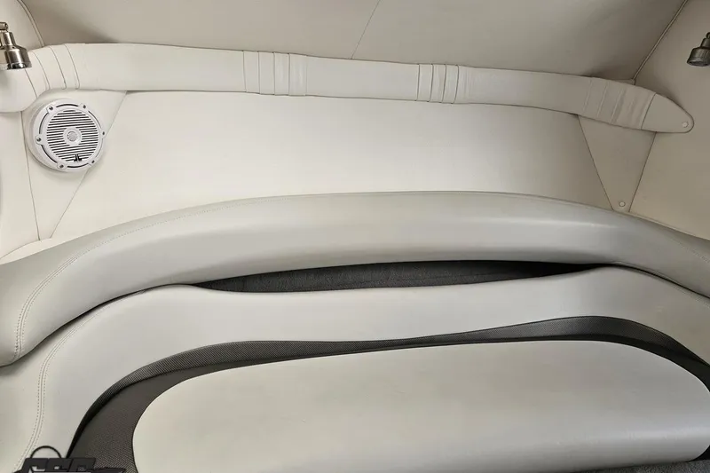 Slide: The Image of 2004 Baja 29 Outlaw boat interior with white seating and speaker detail. - 65