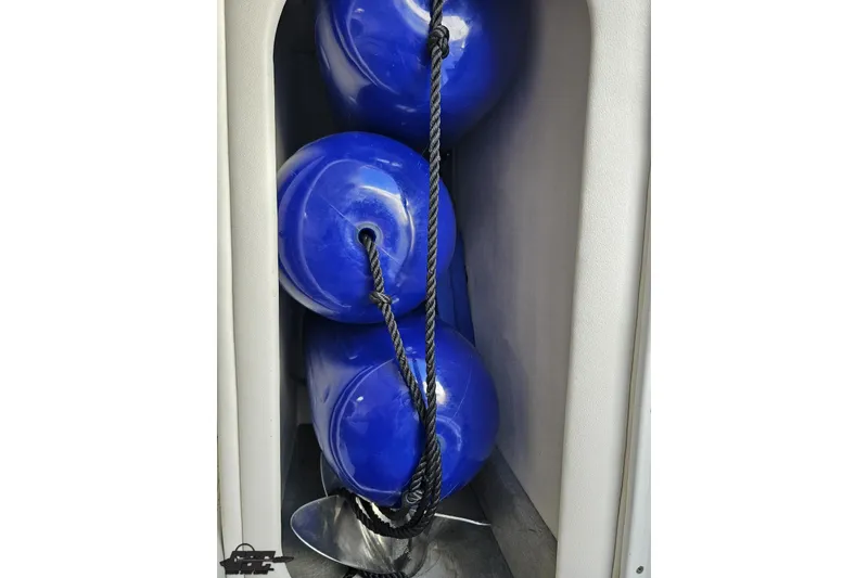 Slide: The Image of Blue boat fenders stored in a compartment of a 2004 Baja 29 Outlaw. - 66