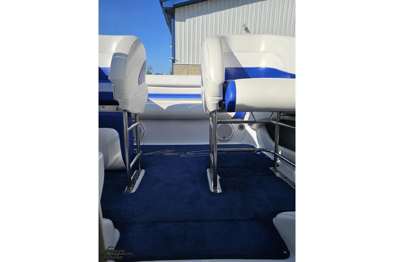 Slide: The Image of 2004 Baja 29 Outlaw boat interior with blue and white seating and carpet. - 69