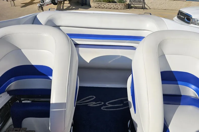 Slide: The Image of 2004 Baja 29 Outlaw boat interior with white and blue seating. - 70