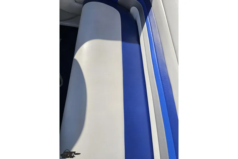 Slide: The Image of 2004 Baja 29 Outlaw boat interior with blue and white seating. - 76