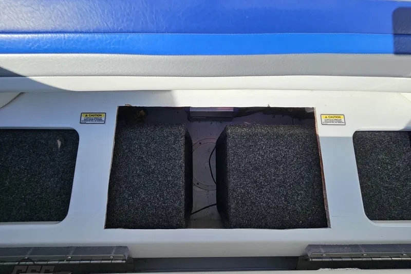 Slide: The Image of 2004 Baja 29 Outlaw boat interior storage compartment with blue and white seating. - 77
