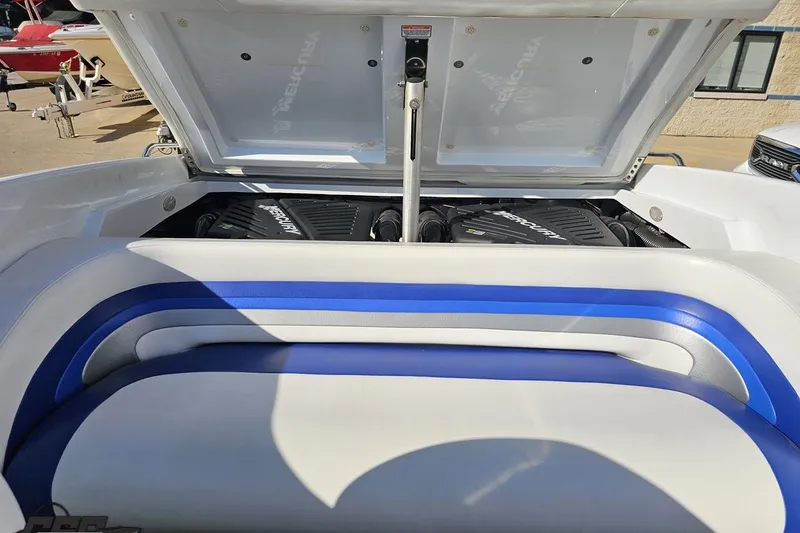 Slide: The Image of 2004 Baja 29 Outlaw boat engine compartment with blue and white seating. - 80