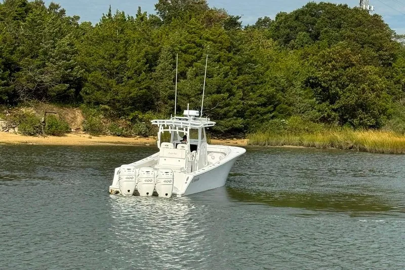 Slide: The Image of 2019 Onslow Bay 33 Tournament boat with quad engines on a serene waterway. - 14