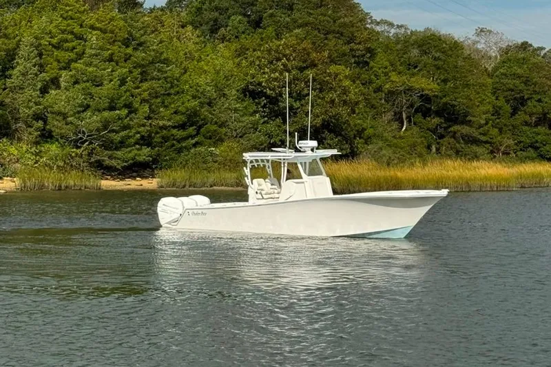 Slide: The Image of 2019 Onslow Bay 33 Tournament boat with quad engines on a serene waterway. - 20