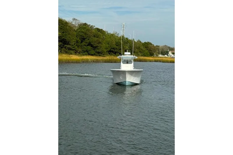 Slide: The Image of 2019 Onslow Bay 33 Tournament boat cruising on a calm river. - 6