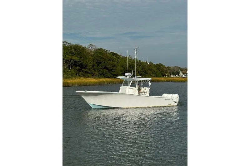 Slide: The Image of 2019 Onslow Bay 33 Tournament boat cruising on a calm river. - 8