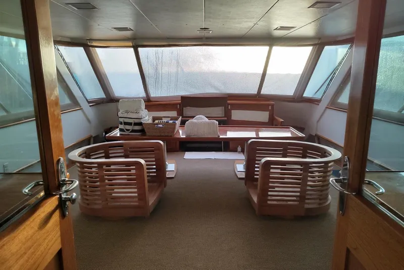 Slide: The Image of Luxurious interior of a 1987 Burger Motoryacht with wooden seating and panoramic windows. - 12