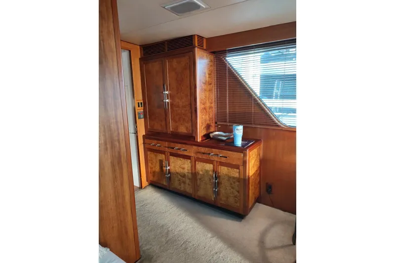 Slide: The Image of Luxurious wood interior of 1987 Burger Motoryacht with cabinets and window blinds. - 14