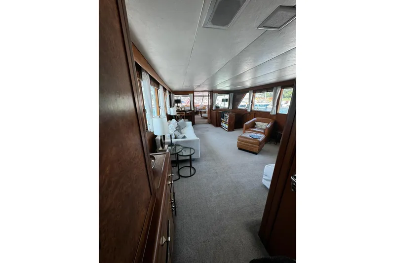 Slide: The Image of Luxurious interior of a 1987 Burger Motoryacht with elegant furnishings and panoramic windows. - 15