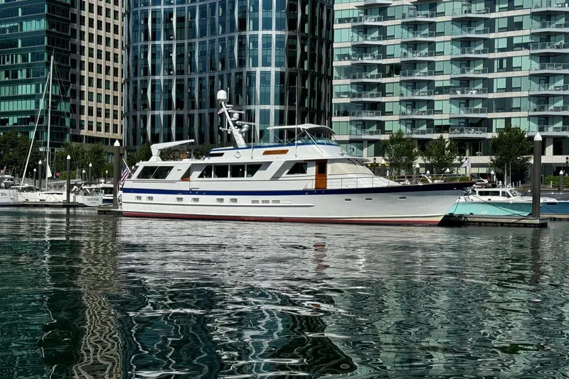 Slide: The Image of 1987 Burger Motoryacht docked in urban marina with modern buildings in background. - 5