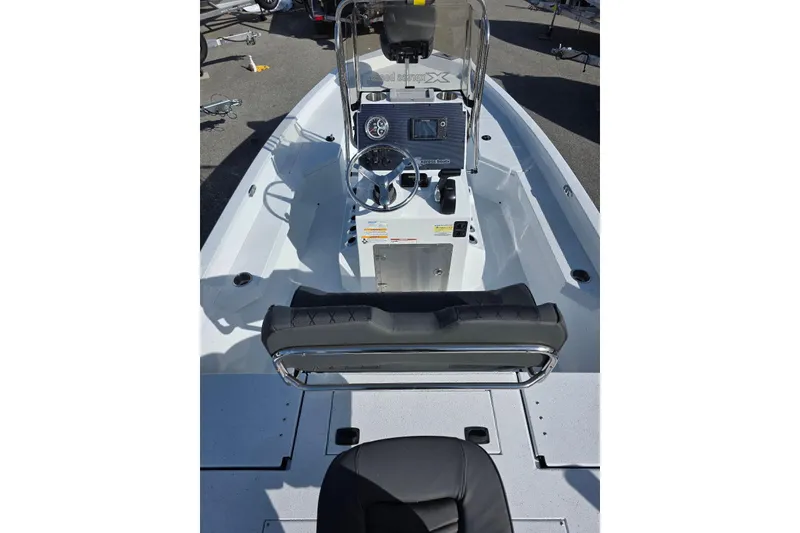 Slide: The Image of 2026 Xpress H20B Bay boat interior with steering console and seating. - 12
