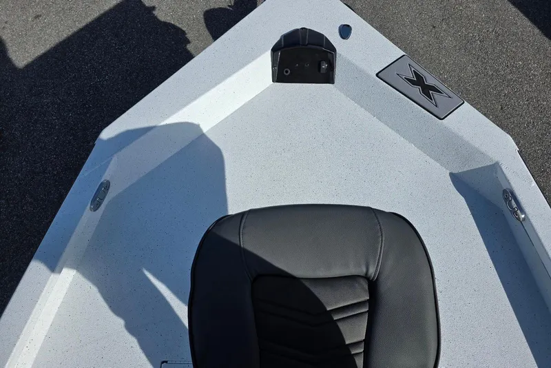 Slide: The Image of 2026 Xpress H20B Bay boat deck with black seat and logo. - 15