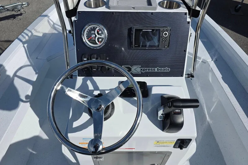 Slide: The Image of 2026 Xpress H20B Bay boat dashboard with steering wheel and control panel. - 21